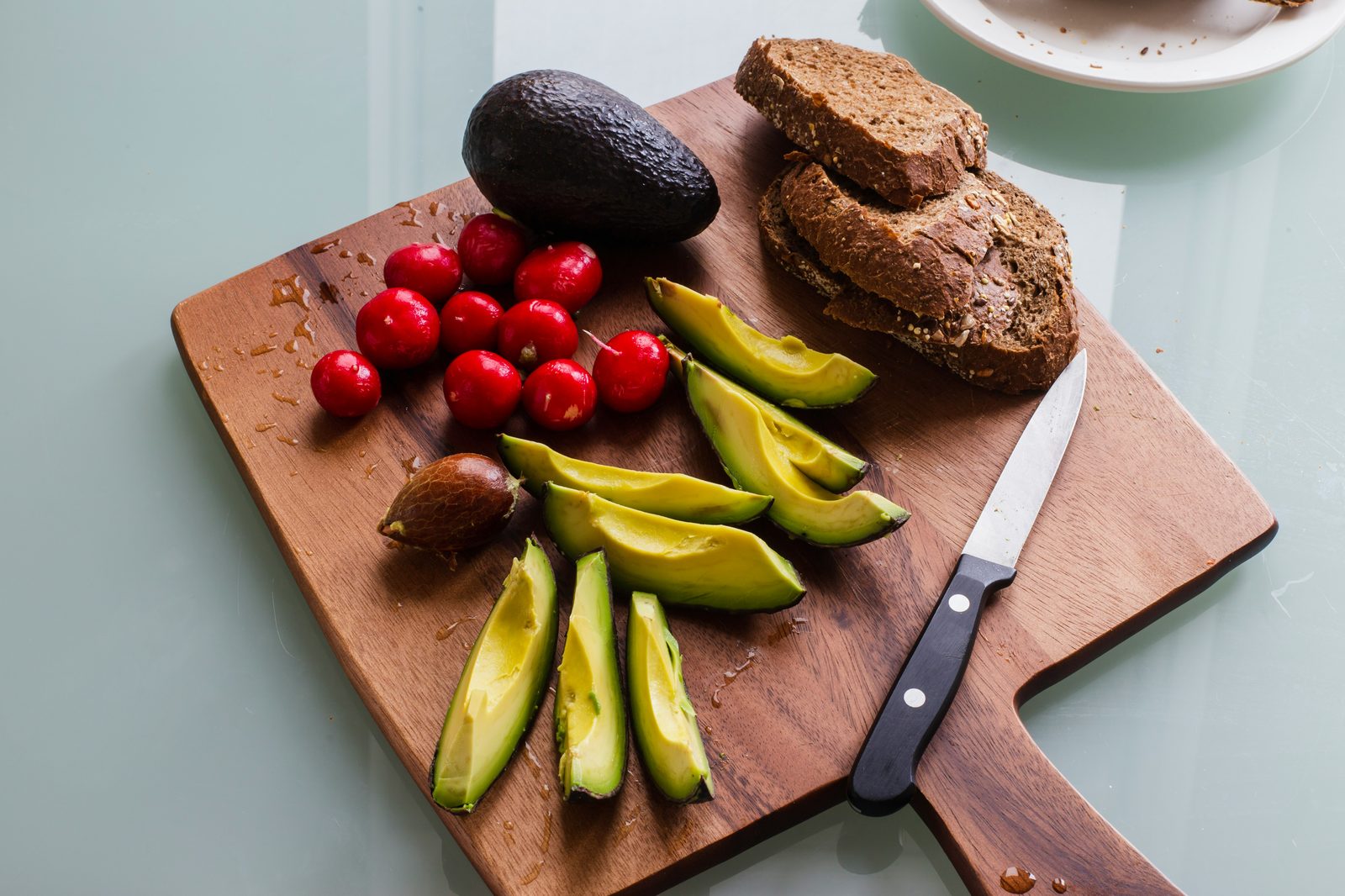 Avocado and low-carb keto-friendly foods on a cutting board