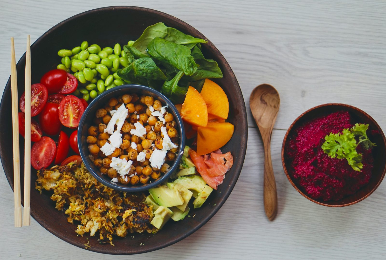 Balanced diet bowl with chickpeas, edamame, spinach, and fresh vegetables