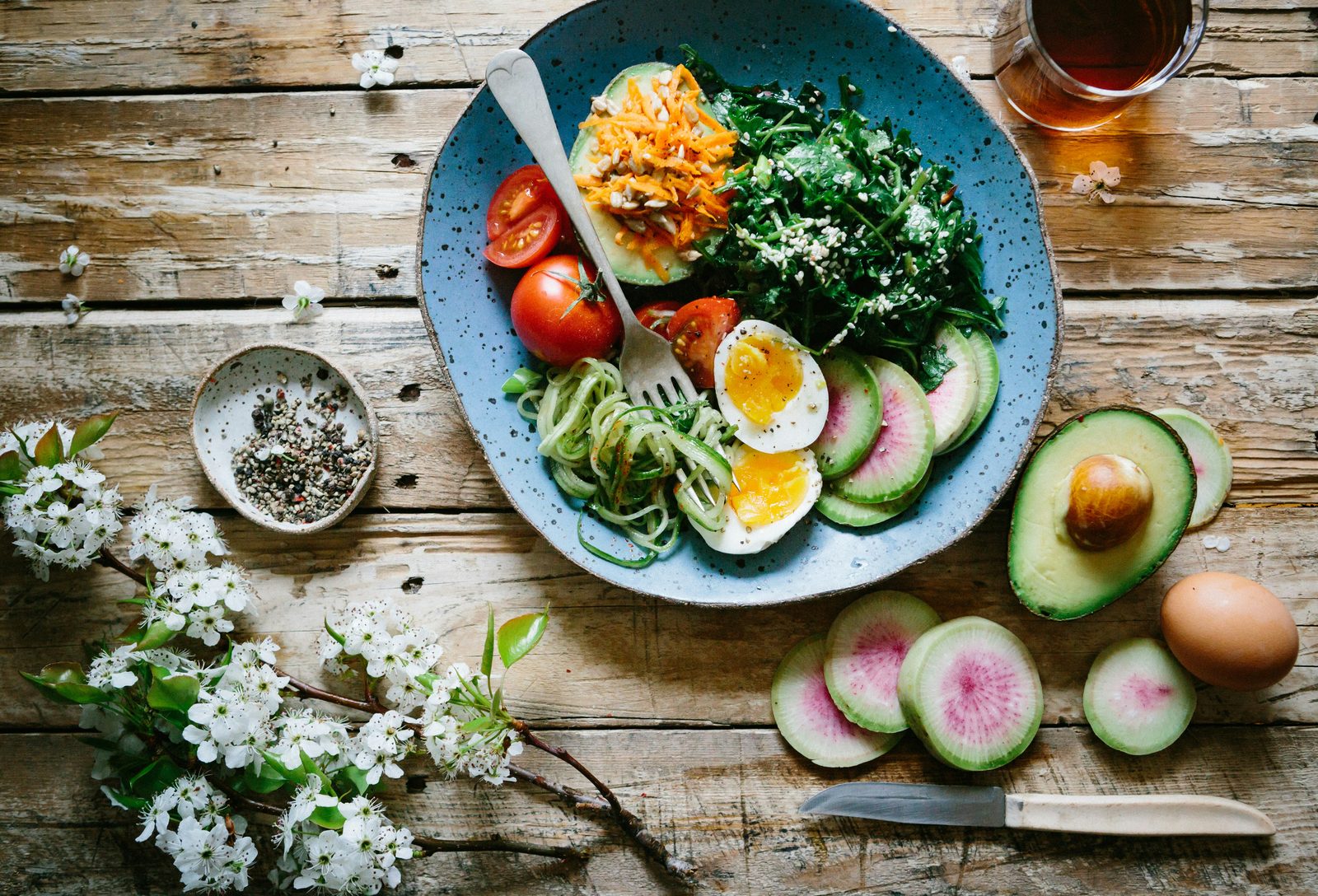 Healthy weight-loss friendly bowl with egg, avocado, radish, and greens